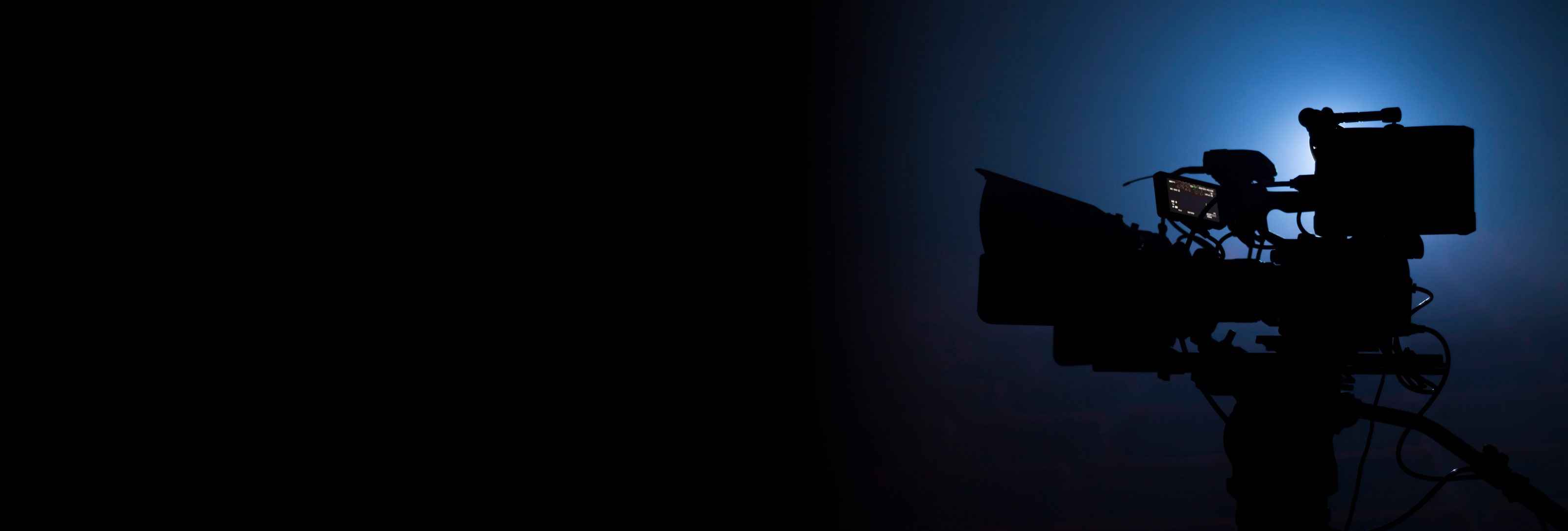 video camera silhouette in the dark banner with blue light, movi